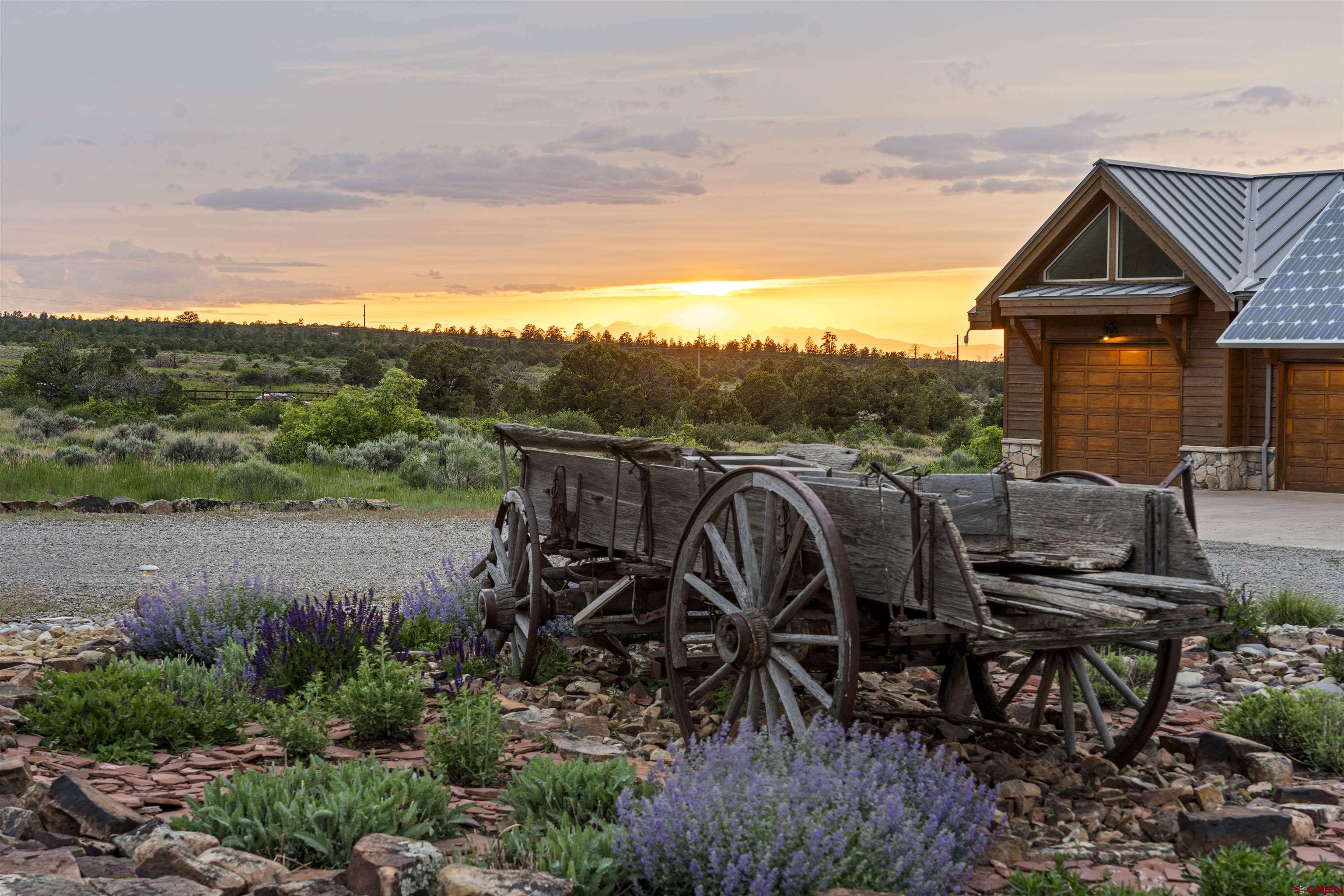 3100 South 44zs Road Norwood, CO 81423 - Photo 2 of 45 a view of a patio with table and chairs a barbeque with potted plants and big yard