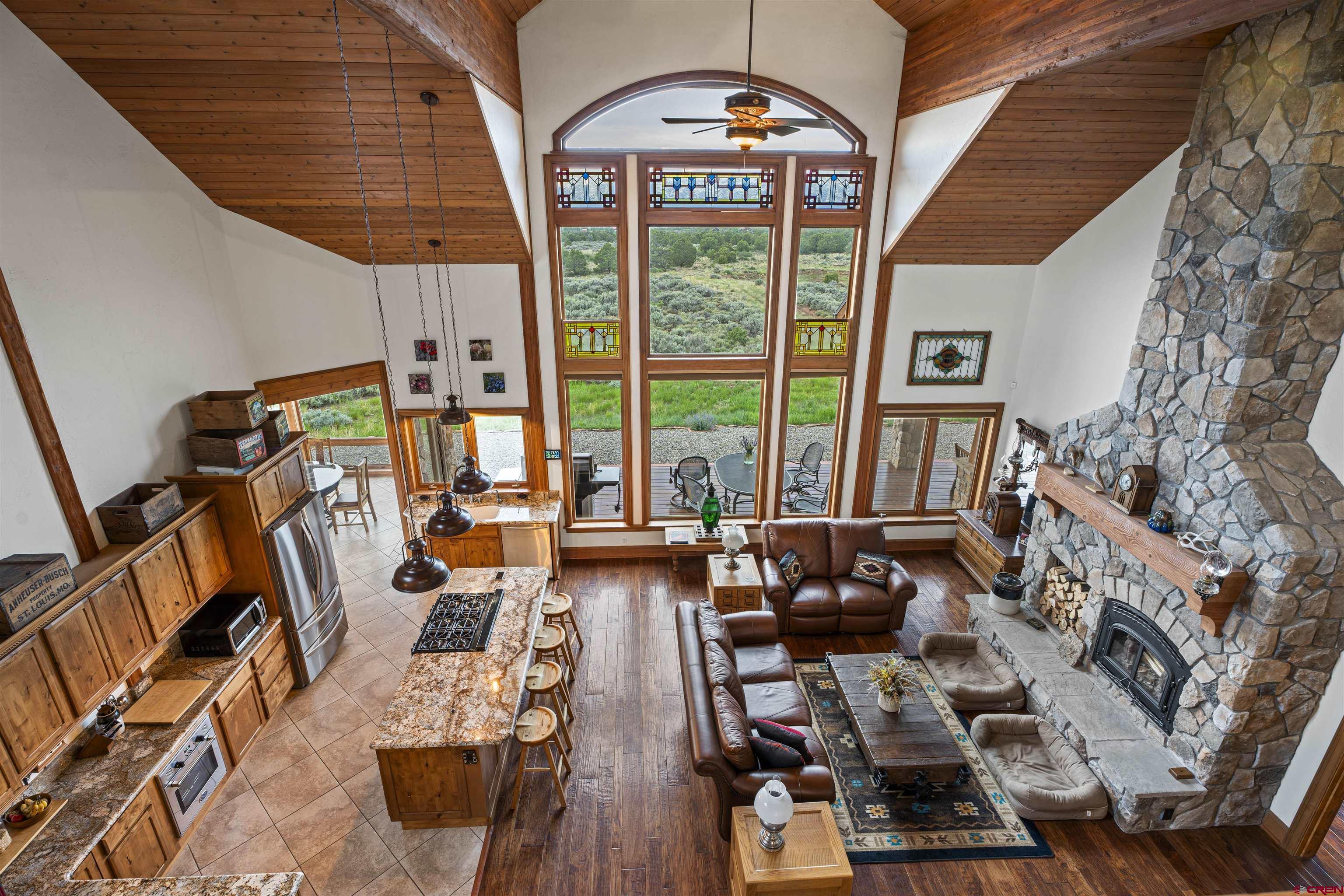 3100 South 44zs Road Norwood, CO 81423 - Photo 26 of 45 a living room with furniture and a floor to ceiling window