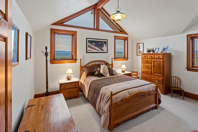 a bedroom with a bed and dresser with mirror