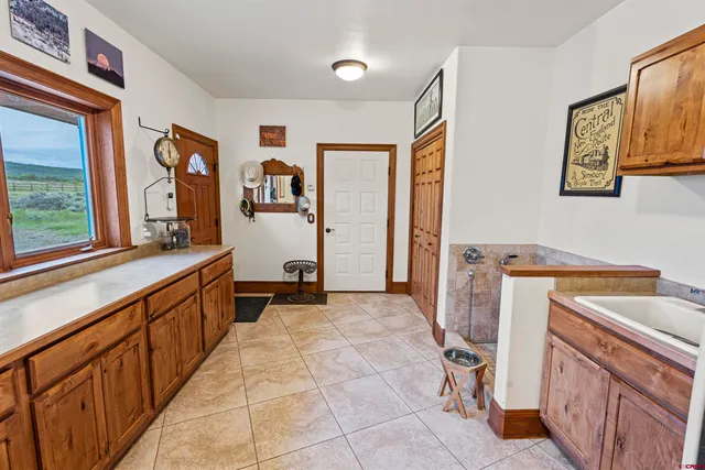 a view of a kitchen with fridge and workspace