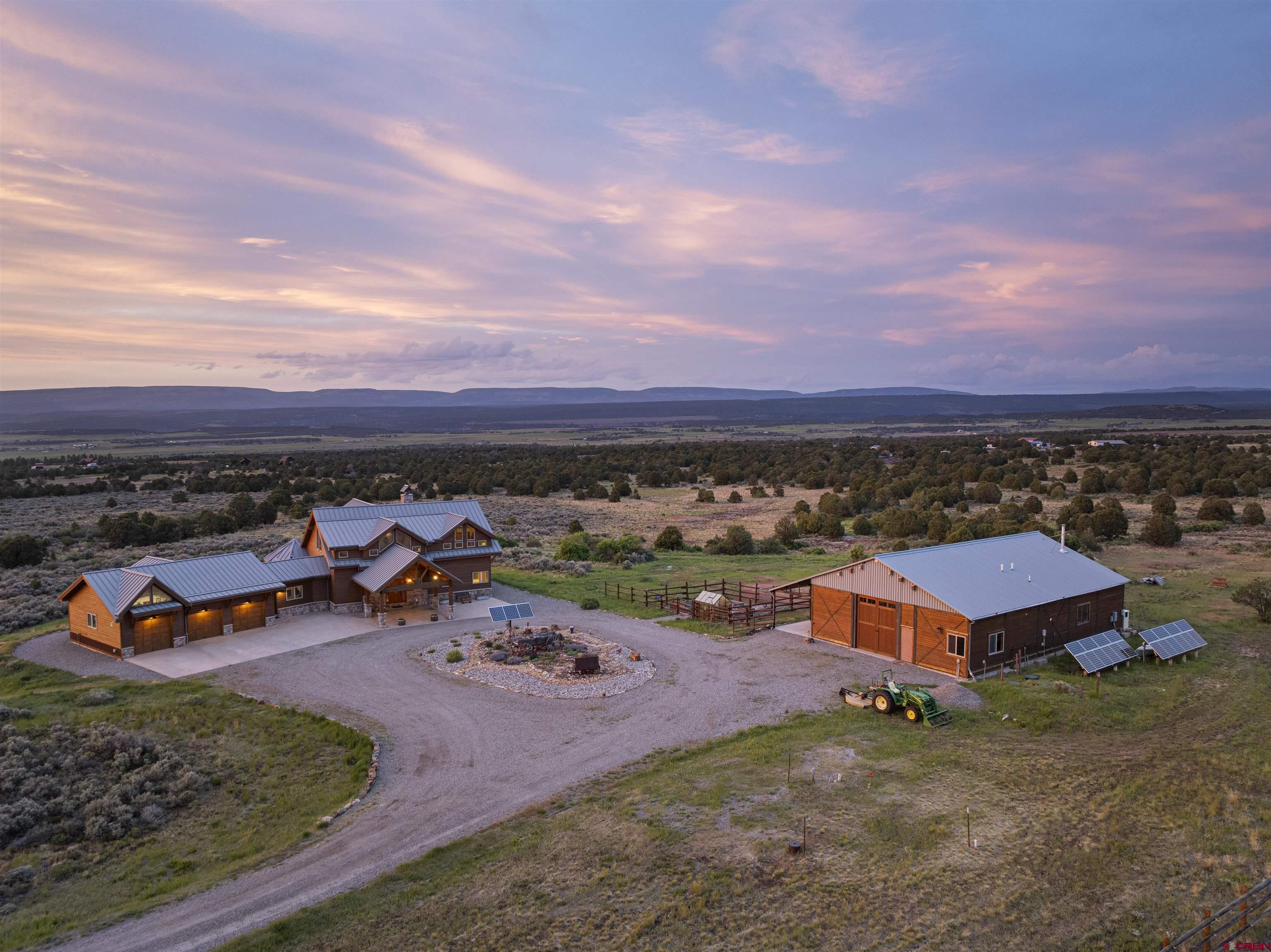 3100 South 44zs Road Norwood, CO 81423 - Photo 8 of 45 an aerial view of a house with a garden and lake view