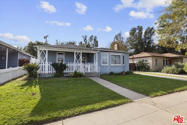 a view of a house with a yard porch and sitting area