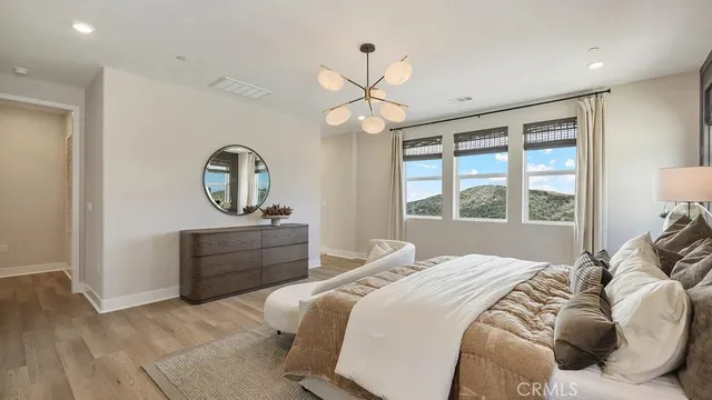 a bed room with a bed mirror and a window