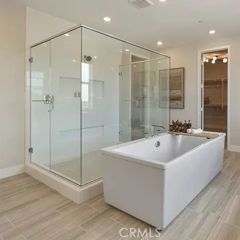 a spacious bathroom with a shower and a sink