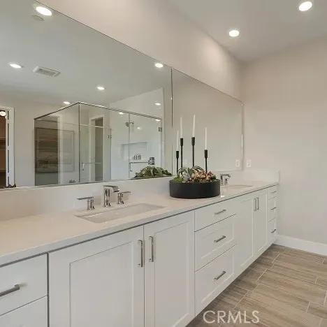 a bathroom with a sink double vanity and a mirror