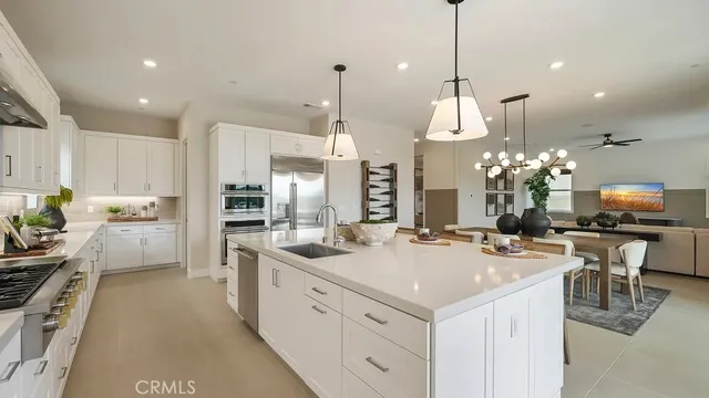 a kitchen with a sink and white cabinets