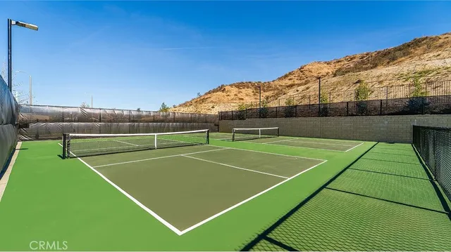 a view of a houses with a big yard and potted plants