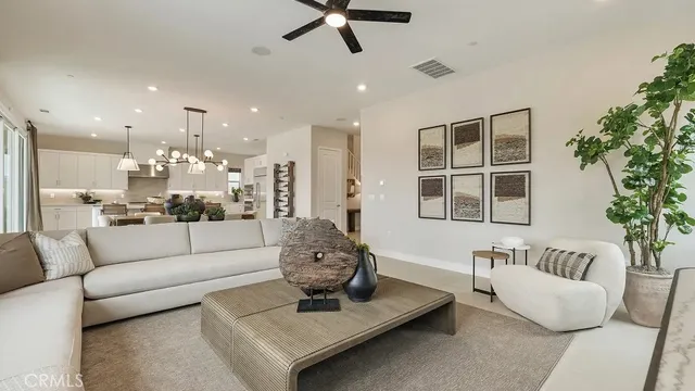 a living room with furniture and kitchen view