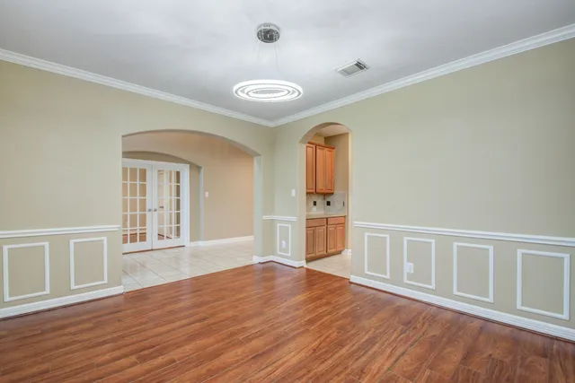 a view of a kitchen with a sink and dishwasher with white cabinets