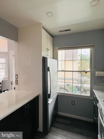 a kitchen with a refrigerator and a sink
