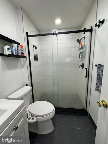 a bathroom with a toilet and a shower