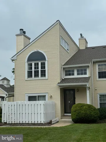 a view of a big house with a yard