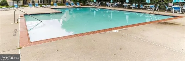 a view of a swimming pool with outdoor seating