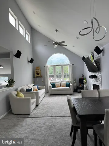 a living room with furniture a window and gym equipment