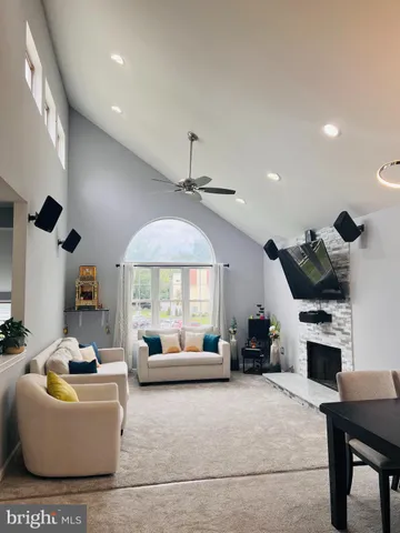 a living room with furniture fireplace and a window
