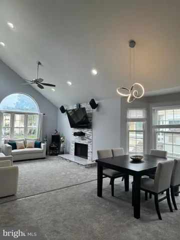 a living room with furniture a window and a clock