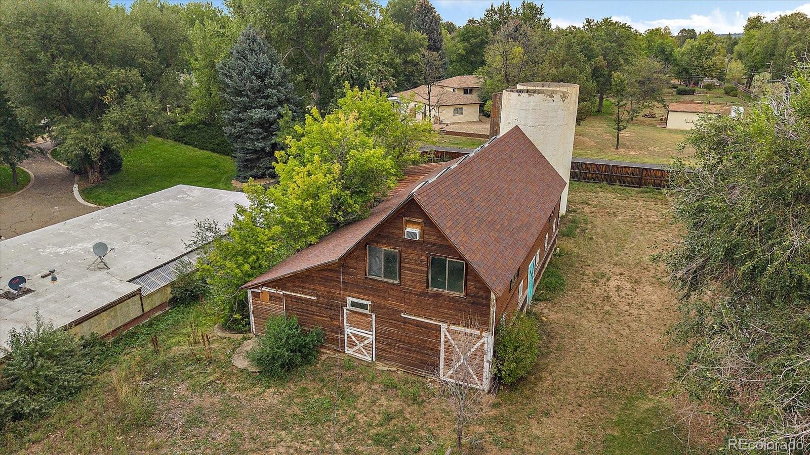 5939 Niwot Road Longmont, CO 80503 - Photo 13 of 25 an aerial view of a house with a yard and large tree