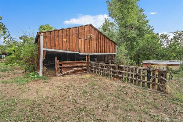 a backyard of a house with plants and lake view