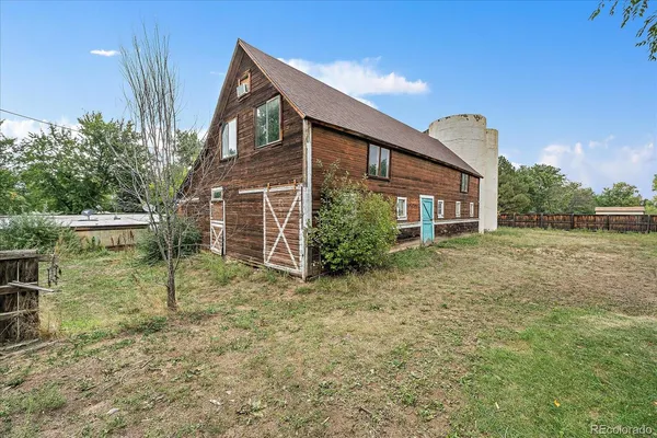 a backyard of a house with yard and outdoor seating