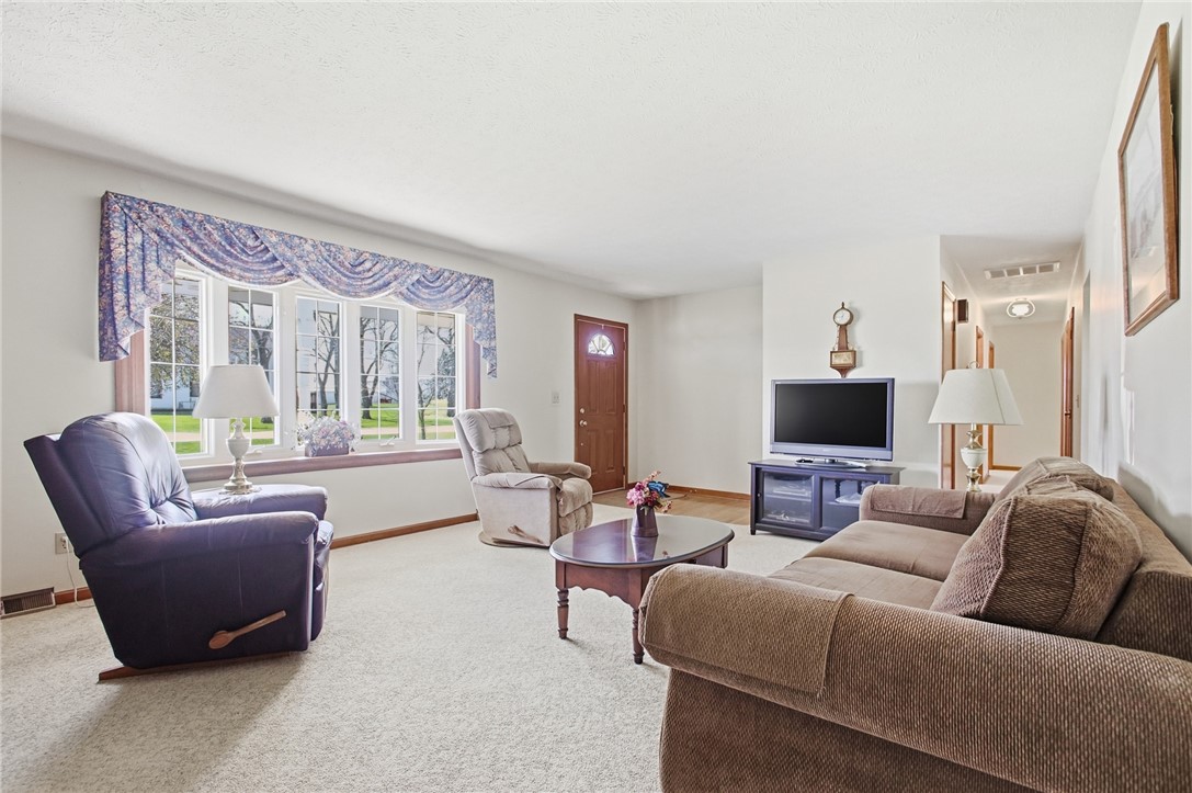 6718 Old Columbus Road South Vienna, OH 45369 - Photo 8 of 33 This inviting living space features ample natural light and plush carpeting, perfect for relaxation and comfort.