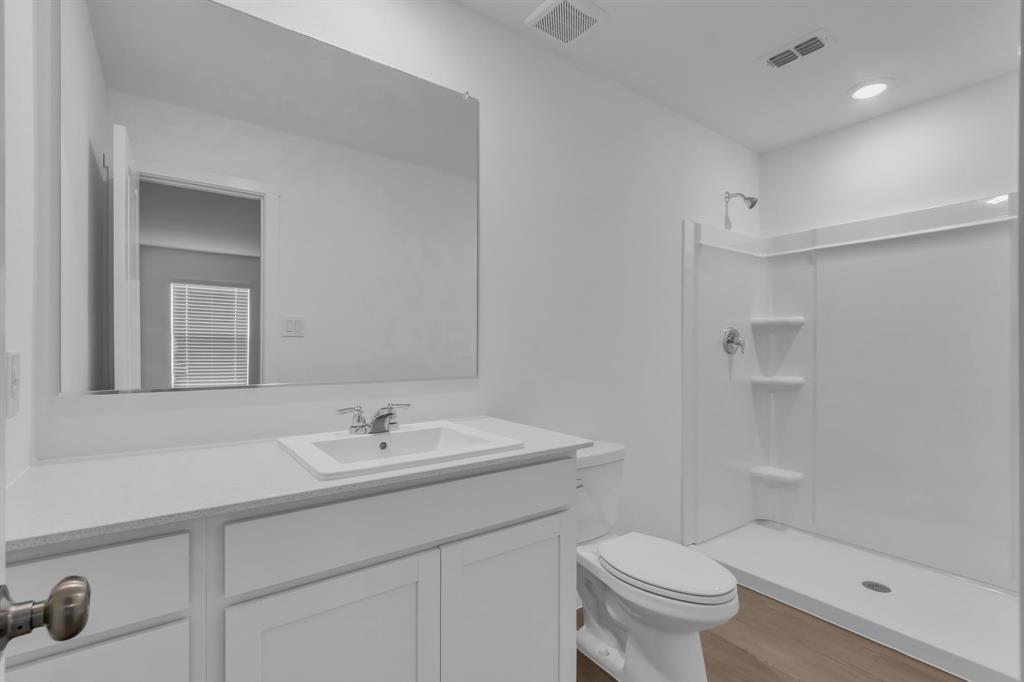 11325 Rodeo Drive Providence Village, TX 76227 - Photo 18 of 40 a bathroom with a sink toilet and shower