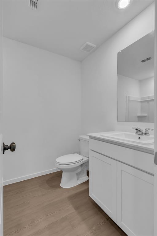 11325 Rodeo Drive Providence Village, TX 76227 - Photo 21 of 40 a bathroom with a toilet a sink a mirror and vanity