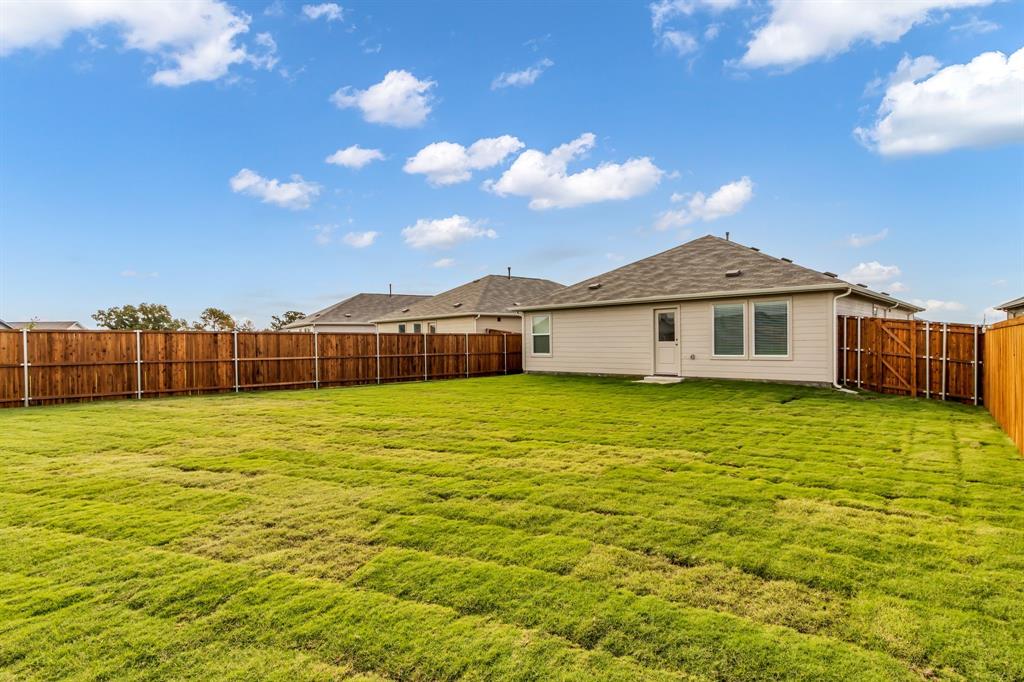 11325 Rodeo Drive Providence Village, TX 76227 - Photo 25 of 40 a front view of a house with a garden