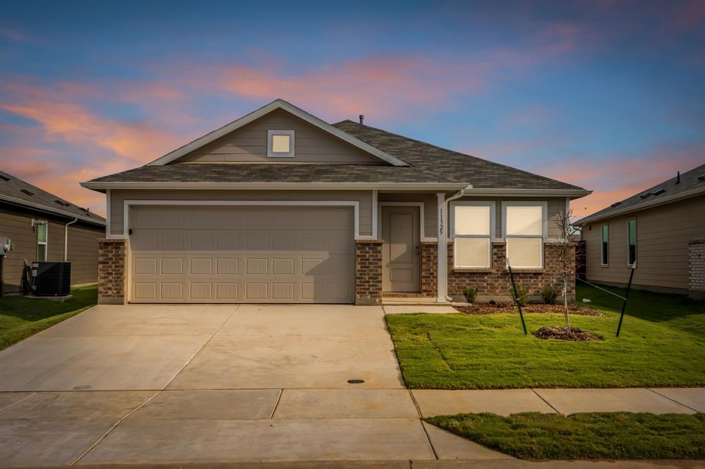 11325 Rodeo Drive Providence Village, TX 76227 - Photo 28 of 40 a front view of a house with garden