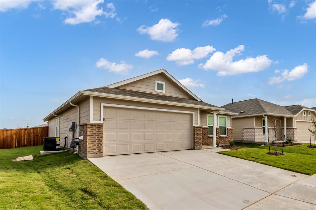 11325 Rodeo Drive Providence Village, TX 76227 - Photo 3 of 40 a front view of a house with garden