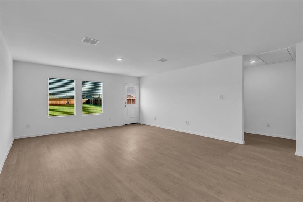 11325 Rodeo Drive Providence Village, TX 76227 - Photo 8 of 40 an empty room with a window and wooden floor