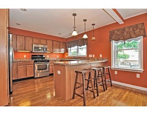 22 Riverside Street Danvers, MA 01923 - Photo 11 of 20 a kitchen with stainless steel appliances granite countertop a stove a sink dishwasher and a refrigerator with wooden floor