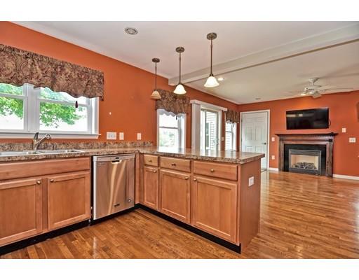 22 Riverside Street Danvers, MA 01923 - Photo 12 of 20 a open kitchen with granite countertop a stove a sink dishwasher and white cabinets with wooden floor