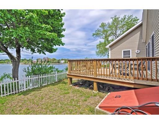 22 Riverside Street Danvers, MA 01923 - Photo 19 of 20 a view of a house with wooden deck and a yard