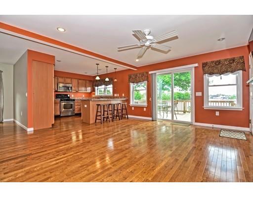 22 Riverside Street Danvers, MA 01923 - Photo 5 of 20 a view of an empty room with a window and wooden floor
