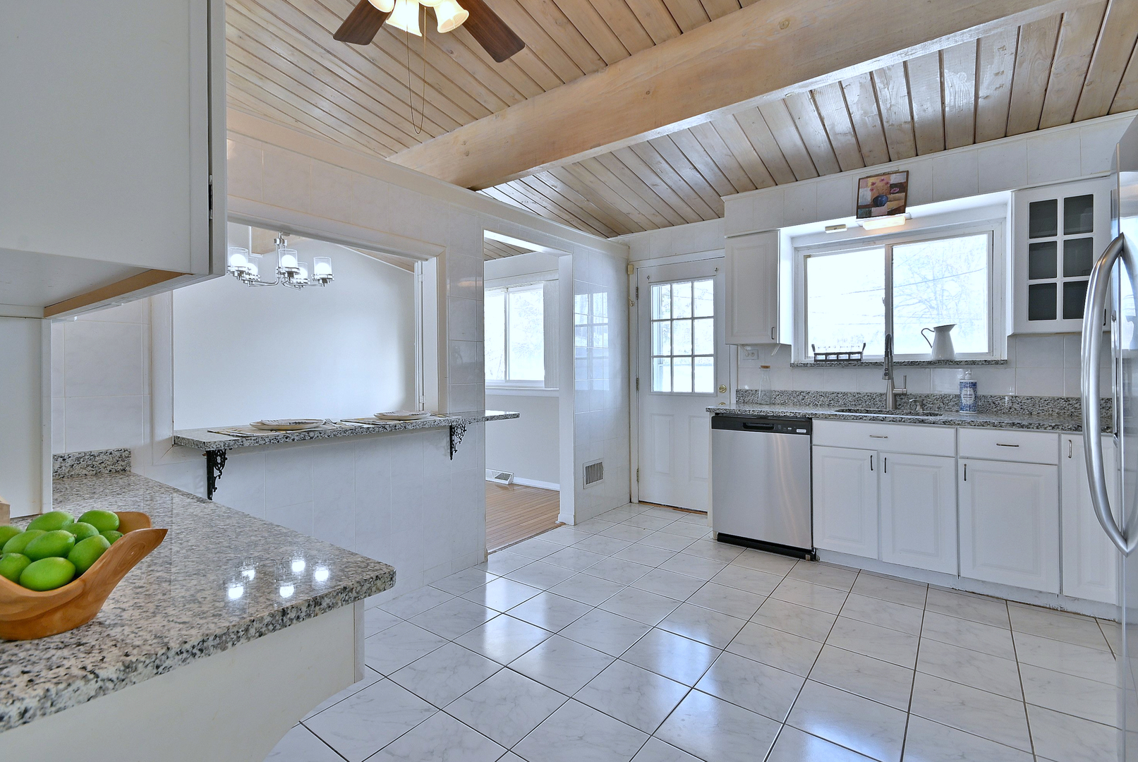 521 Michael Manor Glenview, IL 60025 - Photo 16 of 52 a large kitchen with kitchen island granite countertop a sink and white cabinets