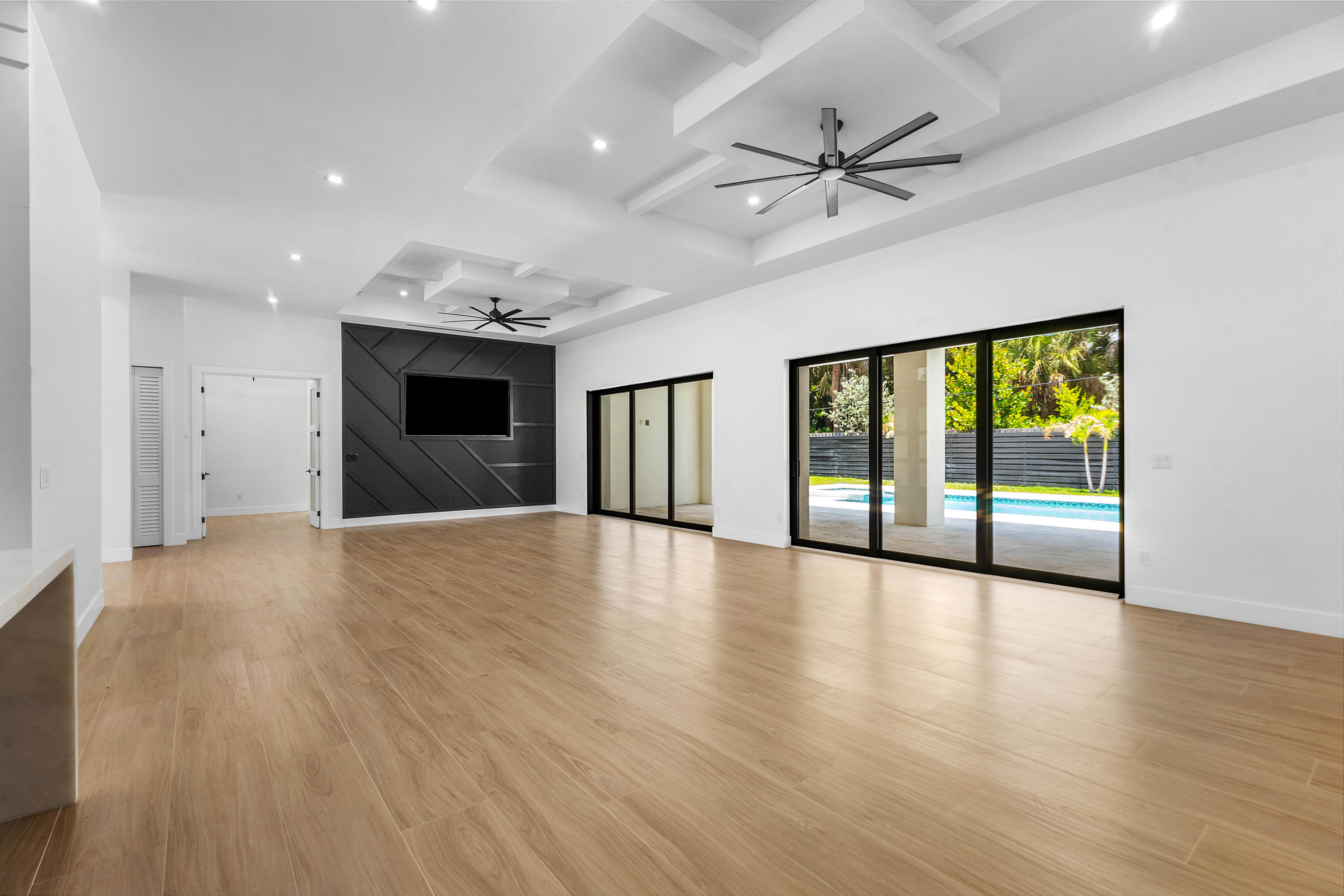 5701 Old Orange Road Jupiter, FL 33458 - Photo 10 of 46 a view of an empty room with a window and wooden floor