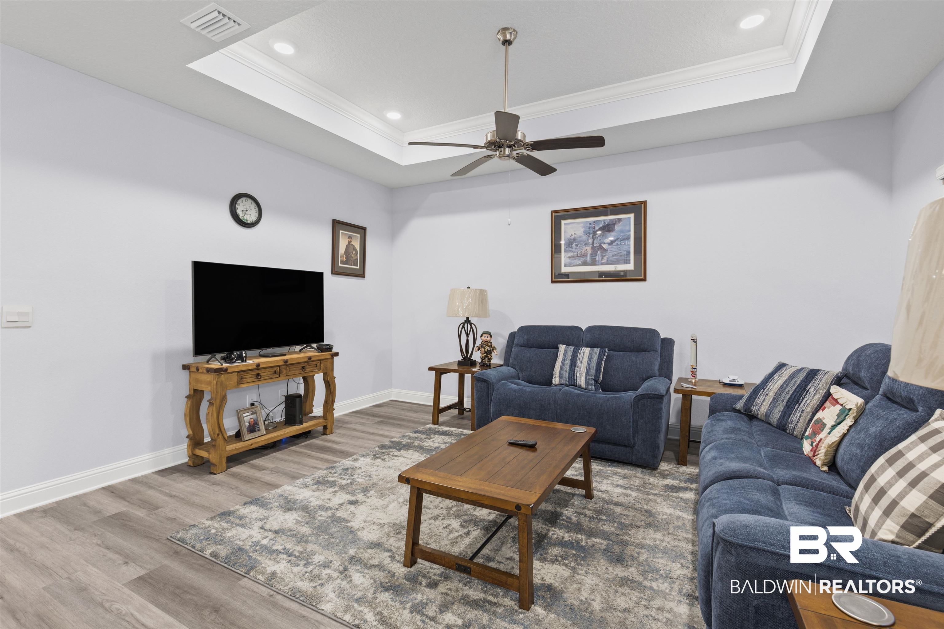 10564 Heirloom Road South Mobile, AL 36608 - Photo 6 of 24 Living room featuring a tray ceiling, crown molding, wood finished floors, ceiling fan, and recessed lighting