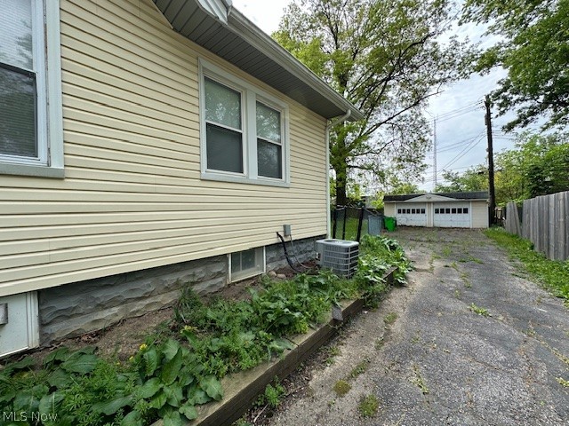1388 Brookline Road Cleveland, OH 44121 - Photo 28 of 30 View of side of property with an outdoor structure, central AC, and a garage