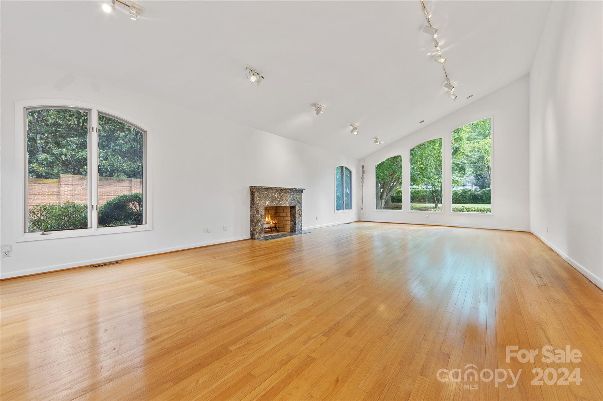 3239 Foxcroft Road Charlotte, NC 28211 - Photo 24 of 42 a view of empty room with wooden floor and fireplace