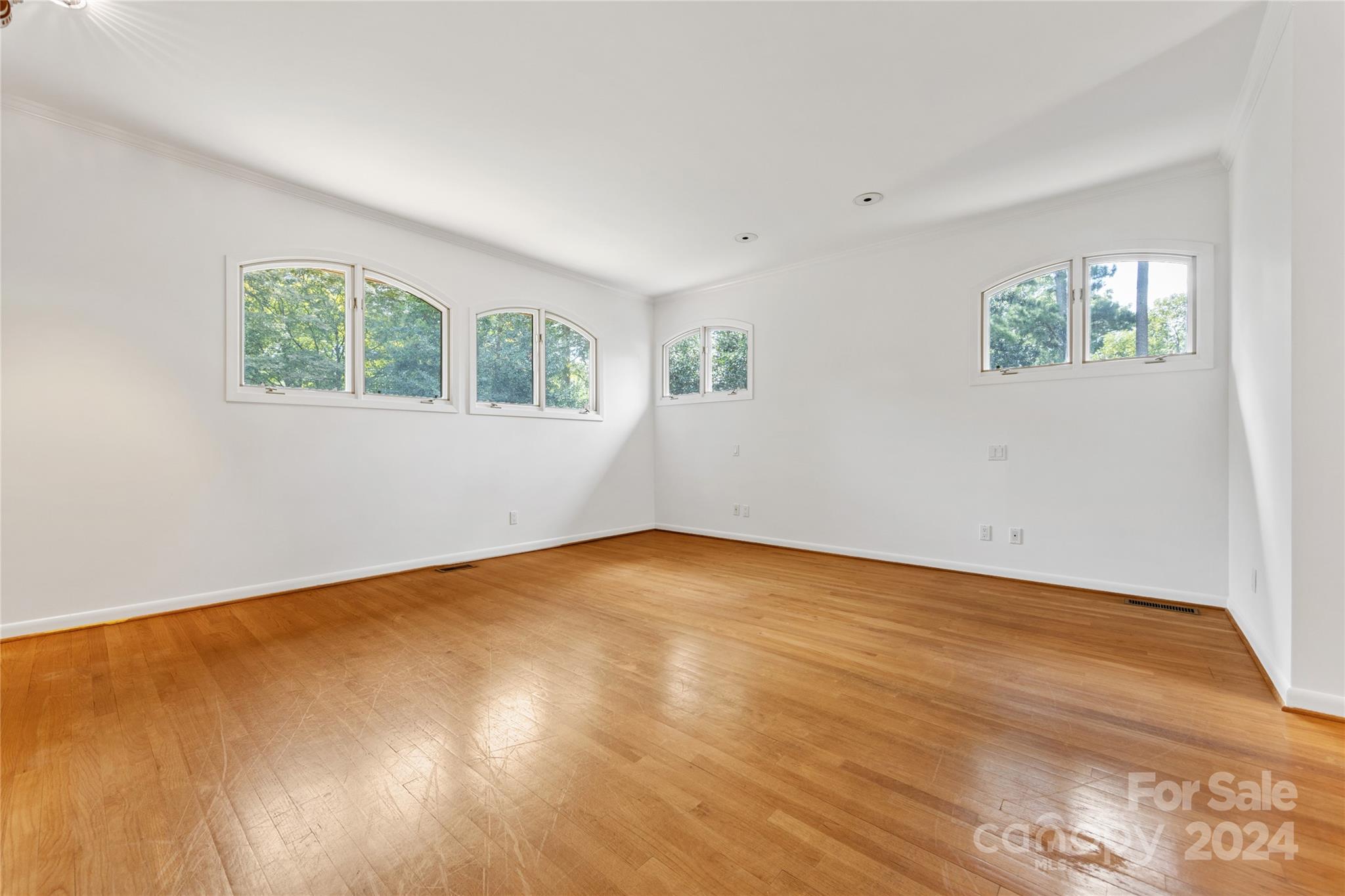 3239 Foxcroft Road Charlotte, NC 28211 - Photo 25 of 42 a view of an empty room with wooden floor and a window