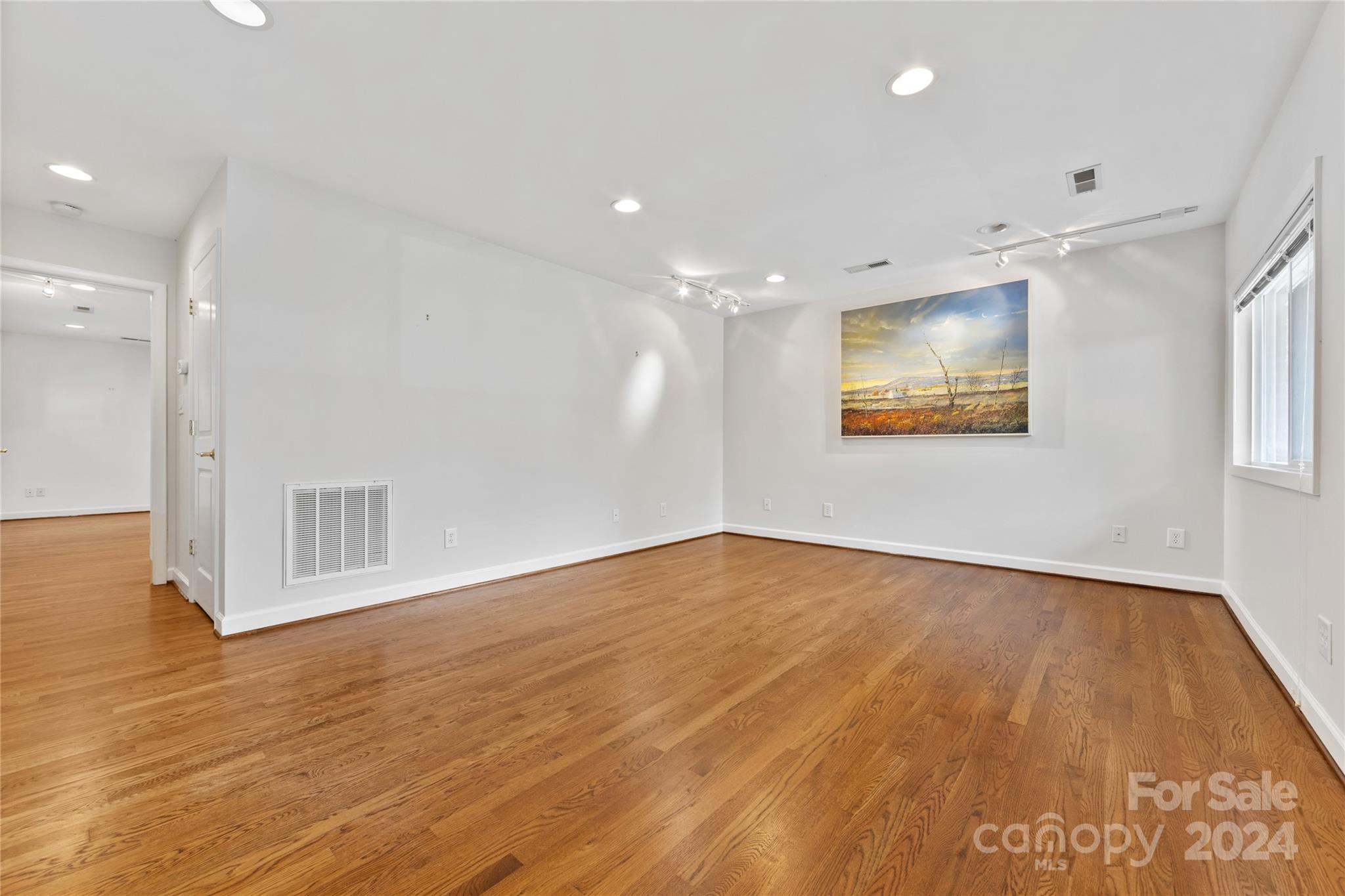 3239 Foxcroft Road Charlotte, NC 28211 - Photo 35 of 42 a view of an empty room with wooden floor and a window