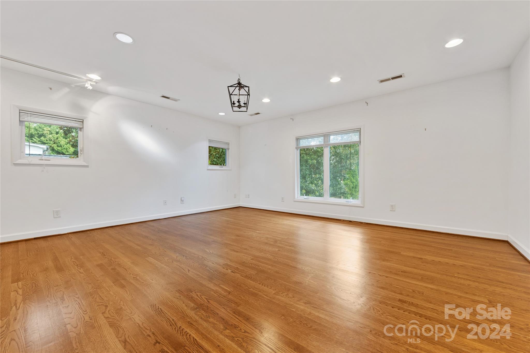 3239 Foxcroft Road Charlotte, NC 28211 - Photo 36 of 42 an empty room with wooden floor and windows