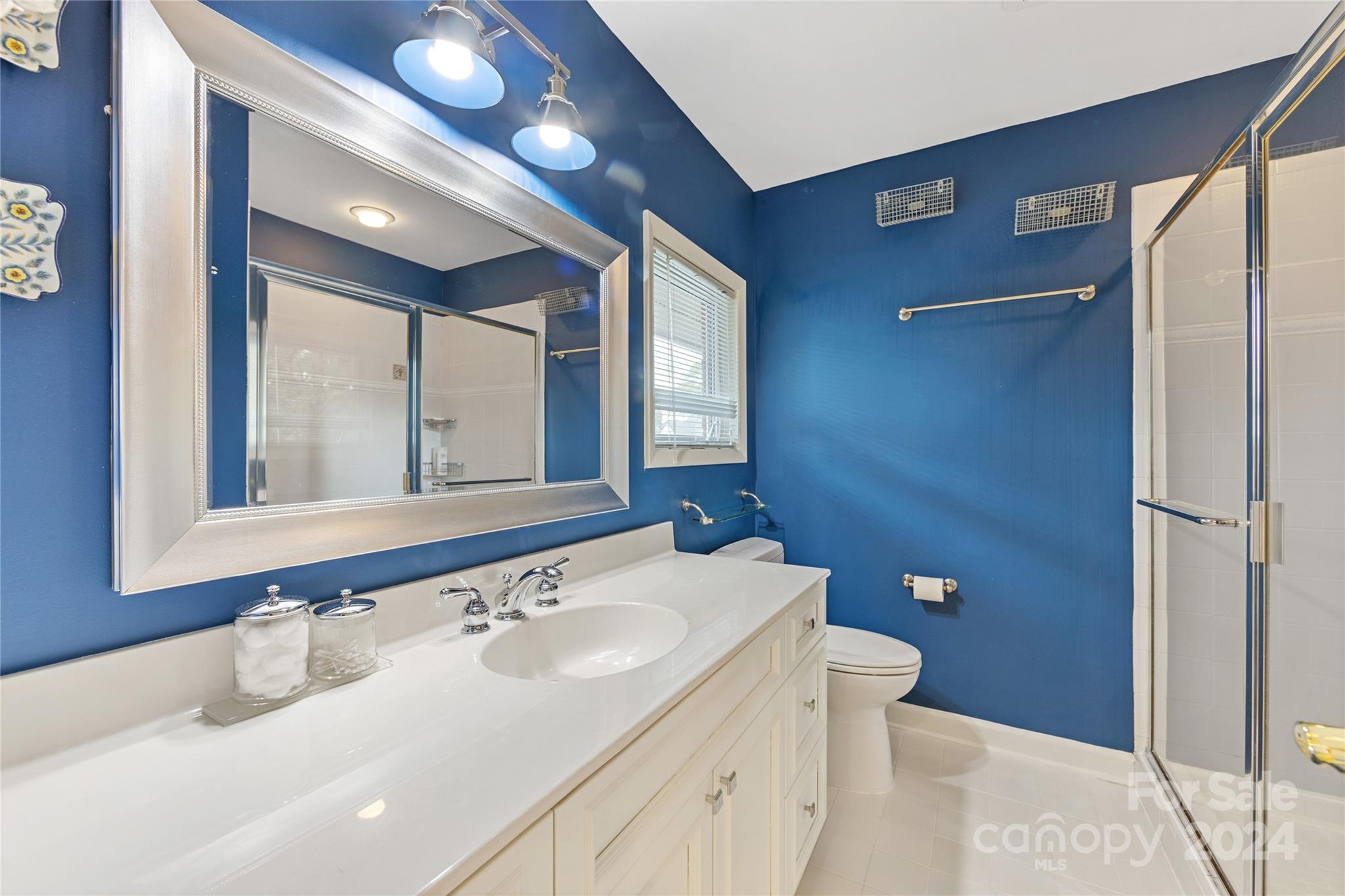 3239 Foxcroft Road Charlotte, NC 28211 - Photo 37 of 42 a bathroom with a sink and a mirror