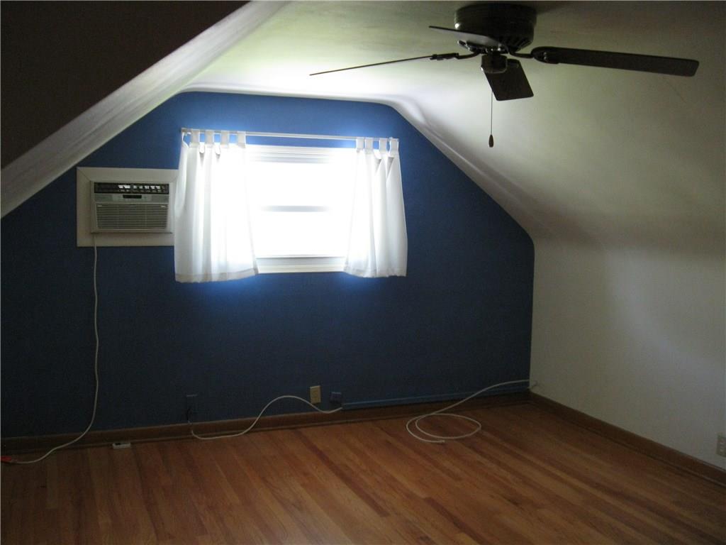 3108 Mercer Road New Castle, PA 16105 - Photo 9 of 17 Second floor bedroom with hardwood floors and window air conditioner.