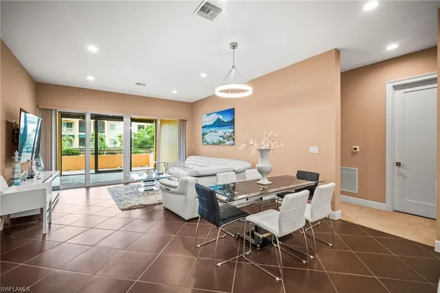 a living room with patio furniture and a large window