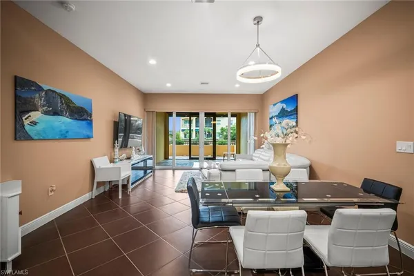 a living room with patio furniture and a large window