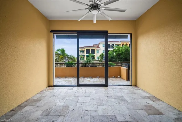 a view of porch with a ceiling fan and a backyard