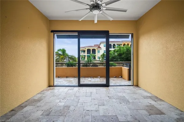 a view of porch with a ceiling fan and a backyard