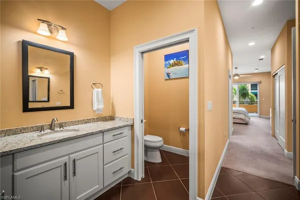 a hall with a sink and a large mirror