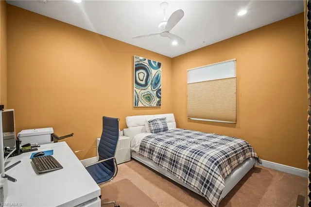 a bedroom with a bed and a desk